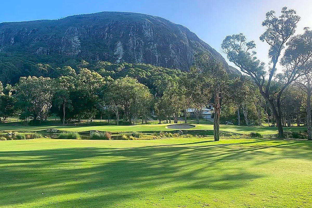 Scenic Mount Coolum Golf Club with mountain backdrop and sand bunker