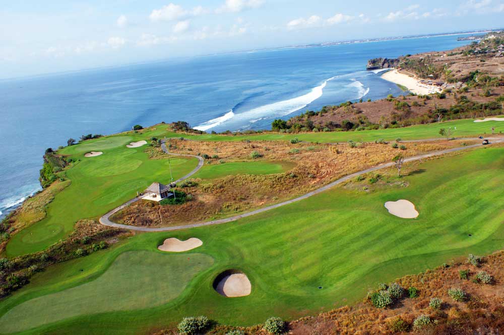 Aerial view of coastal New Kuta Golf with ocean backdrop