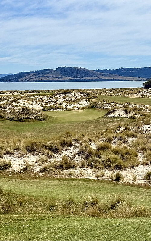 Links golf course with sand dunes beside a coastal bay at 7 Mile Beach Golf