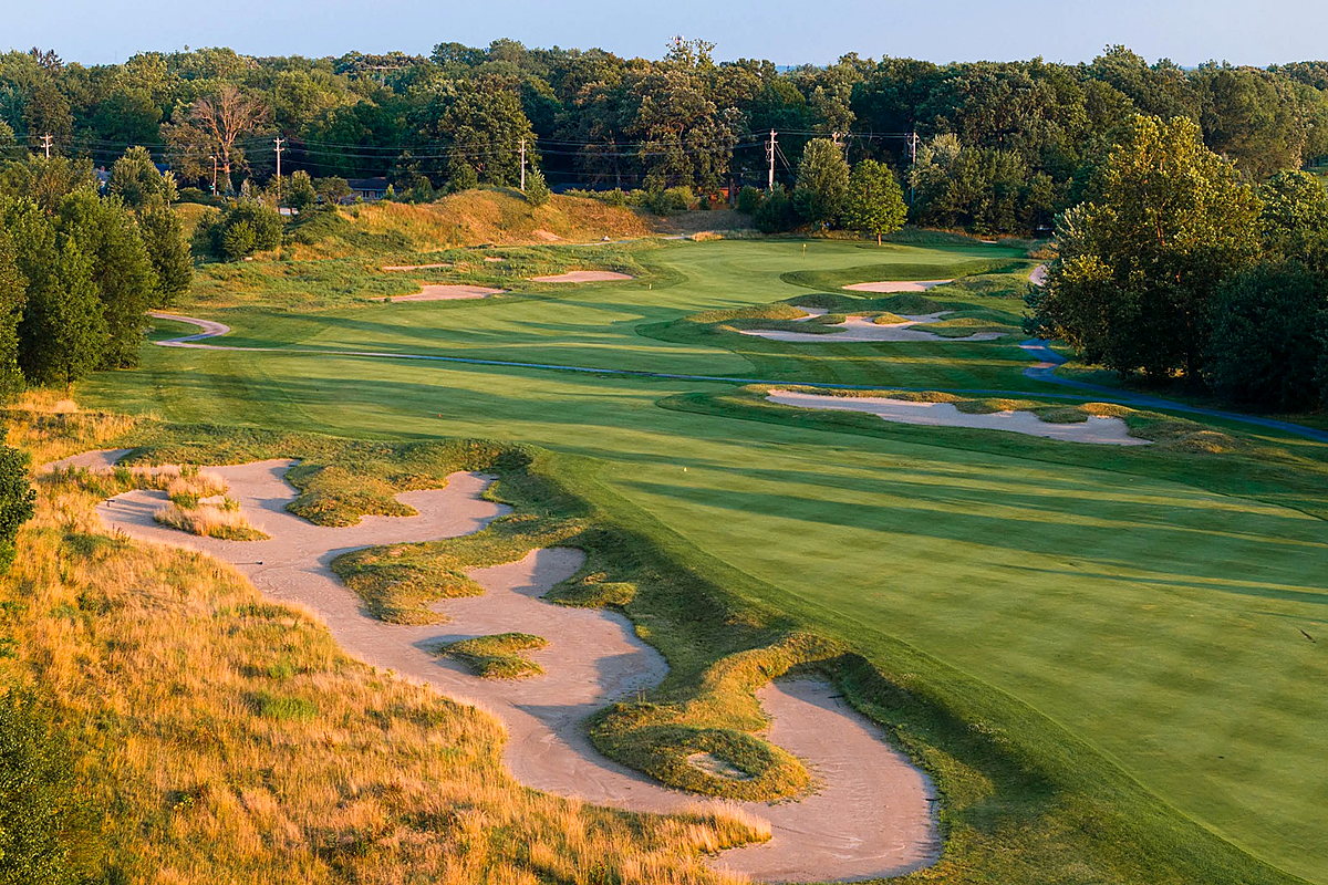 Scenic 7 Mile Beach Golf fairway with sand bunkers and lush trees