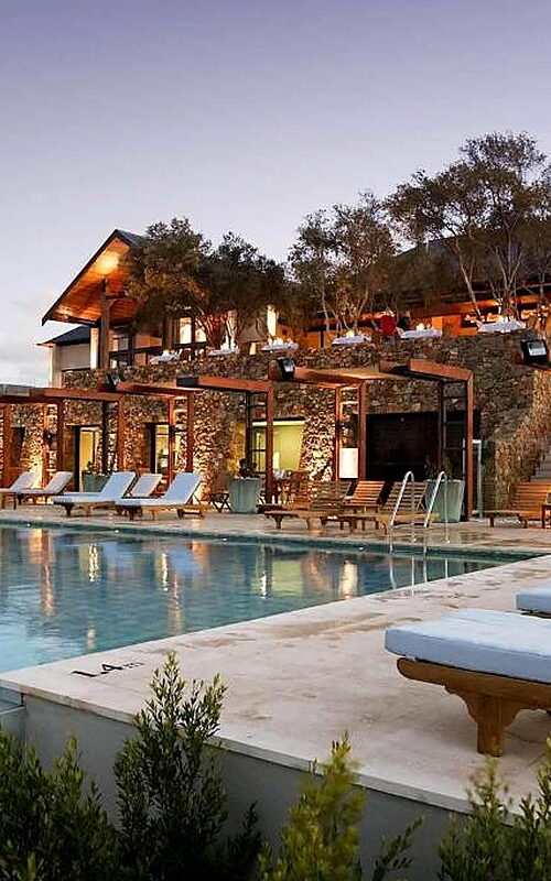 Luxury resort pool with sun loungers at dusk. Pullman Bunker Bay Resort Margaret River Region