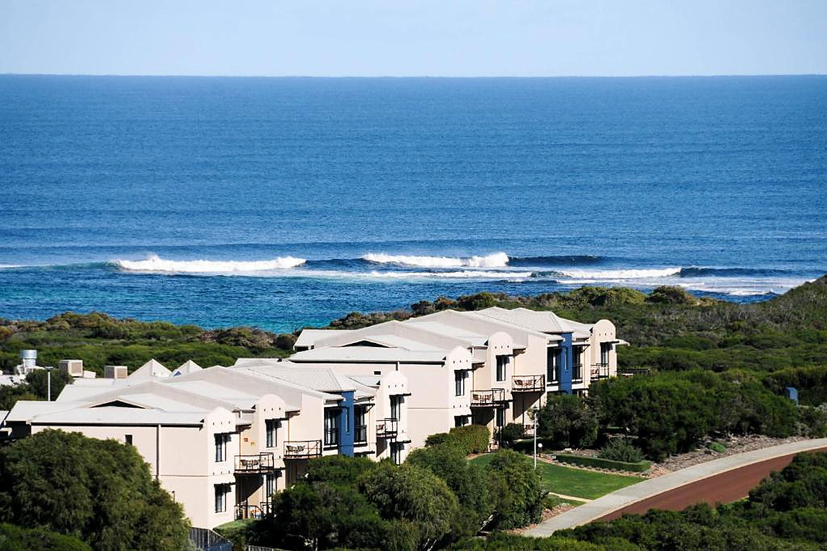 Beachfront resort complex overlooking deep blue Australian ocean