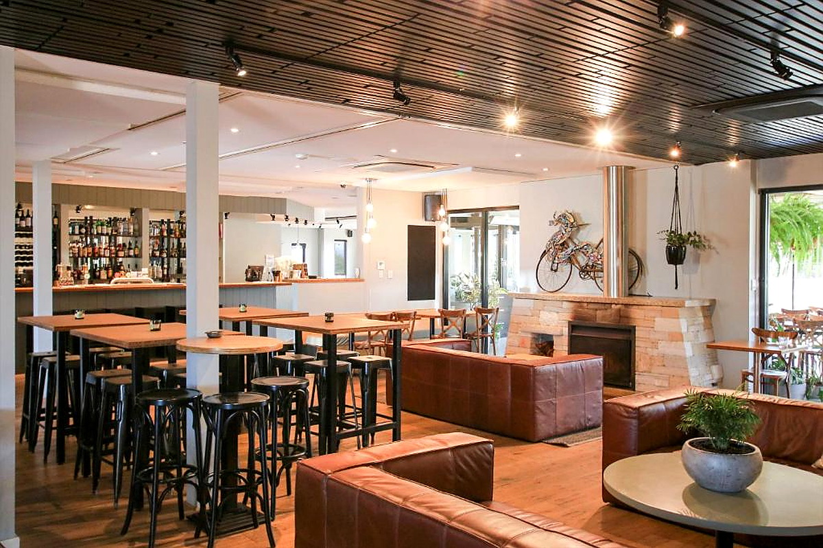 Modern Australian bar and lounge with leather sofas and fireplace