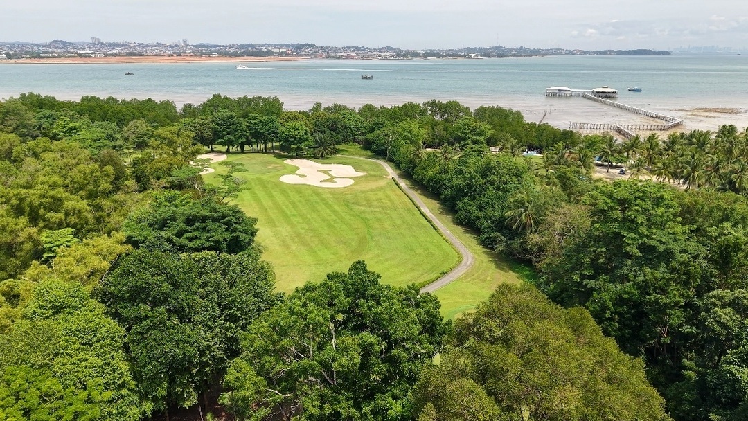 Aerial view of coastal Batam Island Country Club surrounded by lush greenery