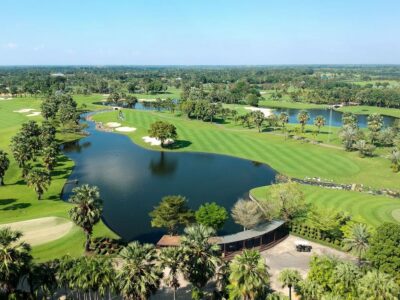 Aerial view of lush tropical Play Suwan Golf & Country Club with lake