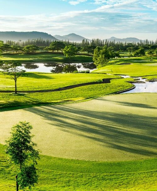 Lush tropical Black Mountain Golf Club with sand bunkers and water hazards