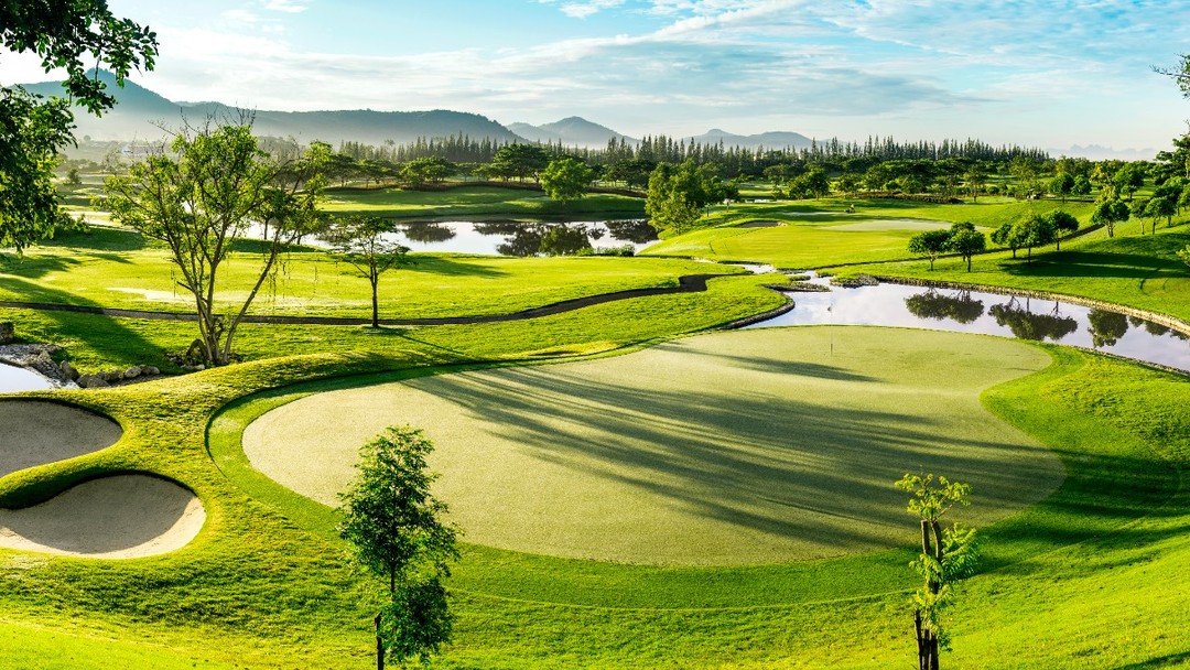 Lush tropical Black Mountain Golf Club with sand bunkers and water hazards
