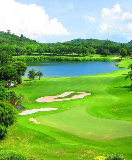Lush tropical Blue Canyon Country Club, Canyon Course with lake and green hills