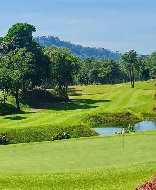 Lush tropical Blue Canyon Country Club, Lakes Course with water hazard and manicured fairways