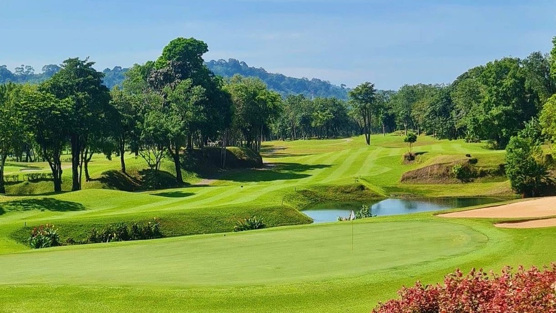 Lush tropical Blue Canyon Country Club, Lakes Course with water hazard and manicured fairways