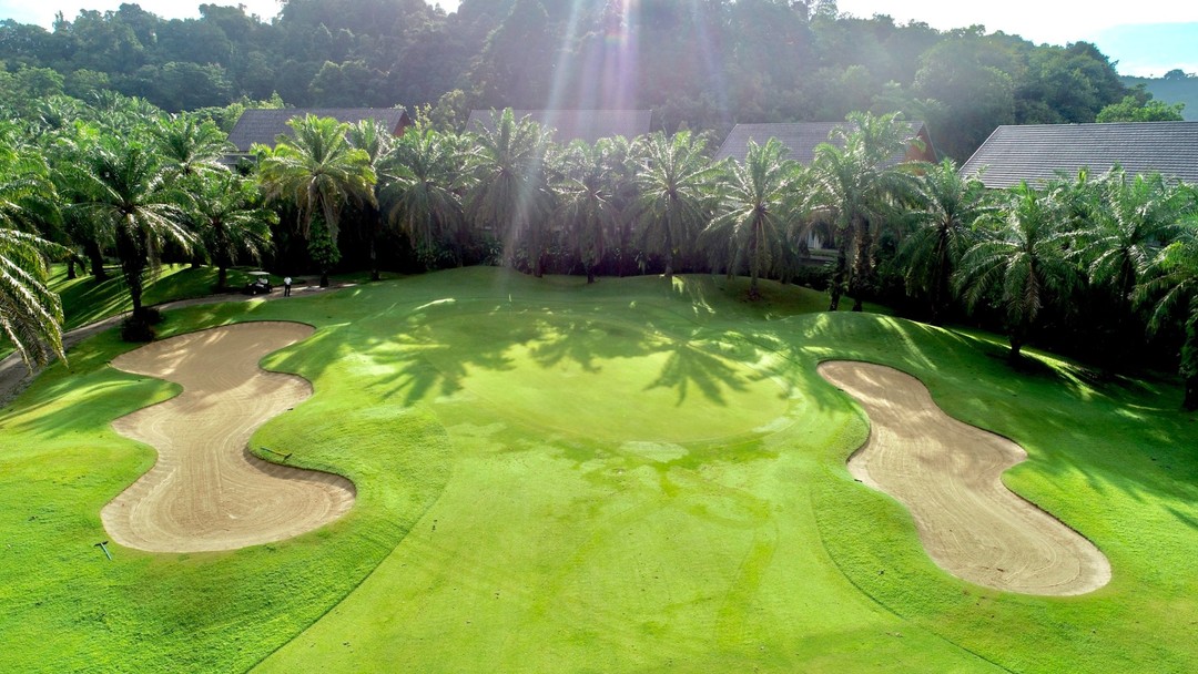 Aerial view of tropical Loch Palm Golf Club with sand bunkers