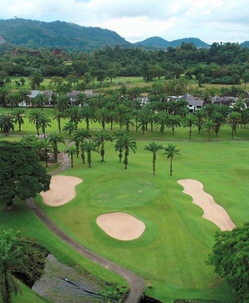 Aerial view of tropical Loch Palm Golf Club with sand bunkers and palms
