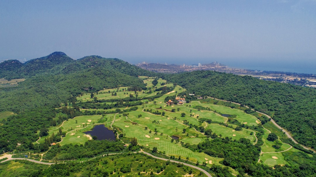 Aerial view of lush Pineapple Valley Golf Club Hua Hin nestled among green hills