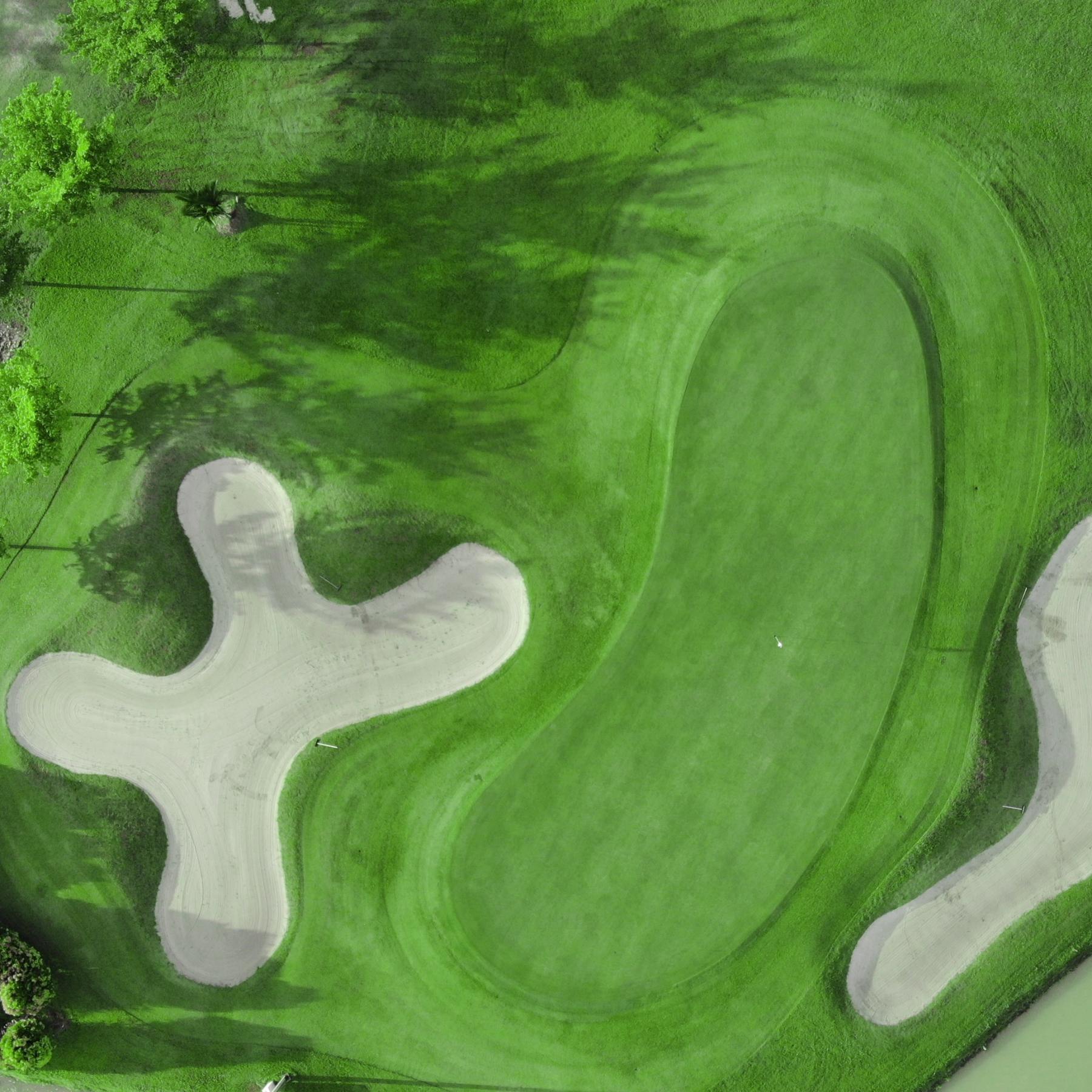Aerial view of Southlinks Country Club course green with sand bunkers