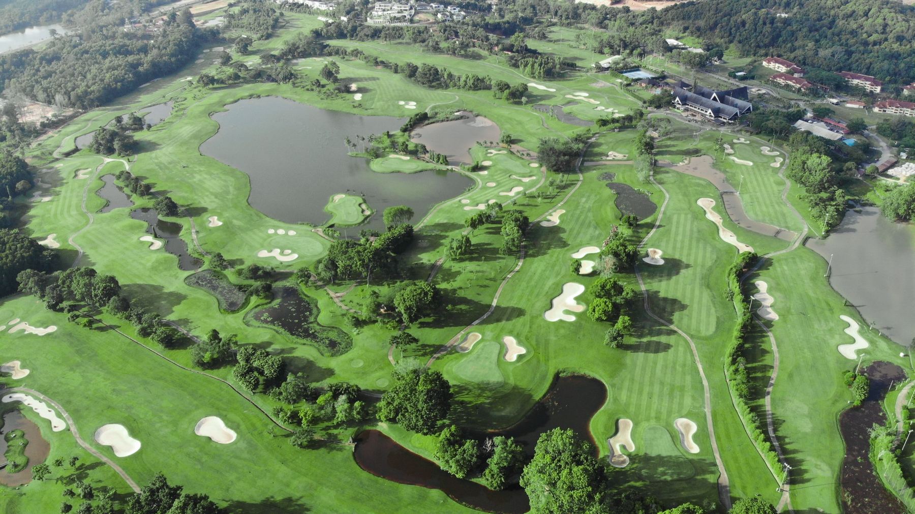 Aerial view of lush tropical Southlinks Country Club with lakes