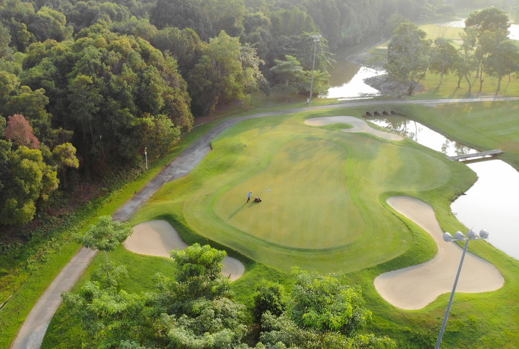 Aerial view of lush Southlinks Country Club green with sand bunkers