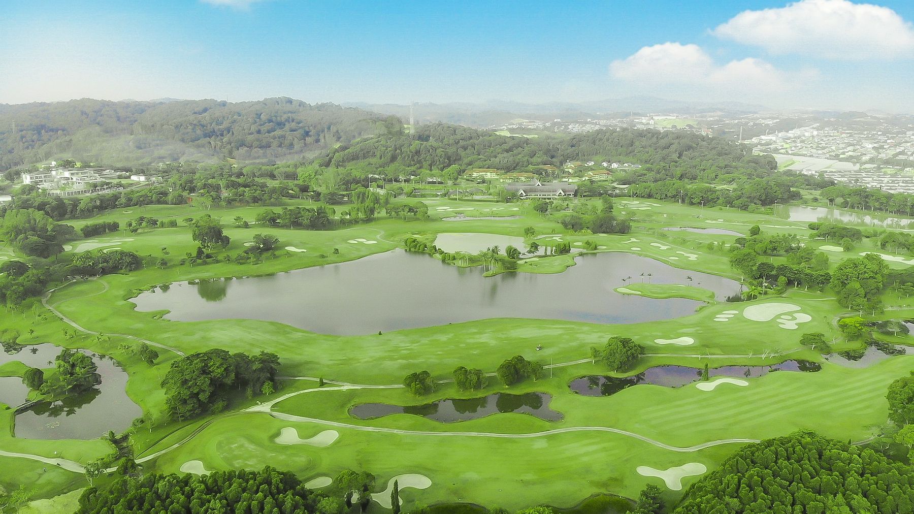 Aerial view of lush green Batam Island Country Club with lakes