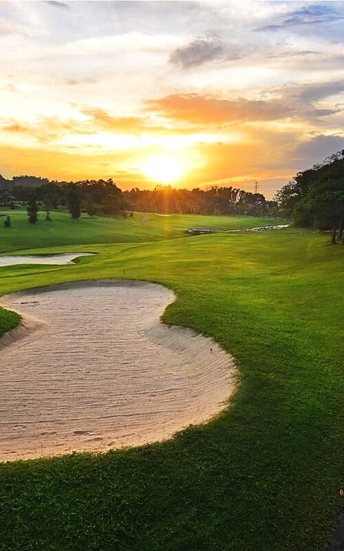 Scenic Batam Hills Golf Resort golf course with sand bunkers at sunset