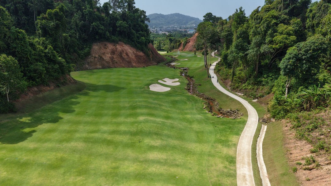 Aerial view of lush Red Mountain Golf Club surrounded by tropical forest