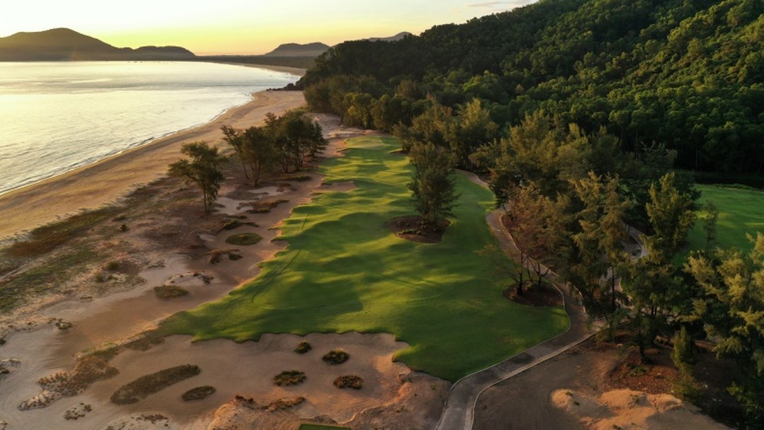 Aerial view of coastal golf course at sunset