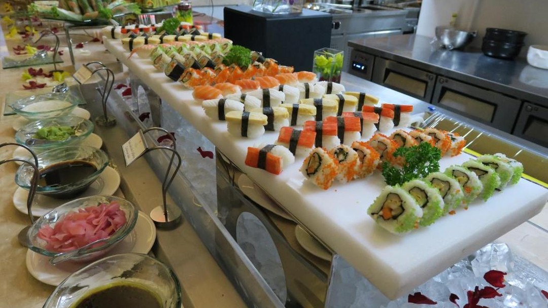 Elaborate sushi buffet spread with various rolls and nigiri