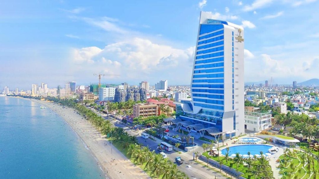 Modern beachfront hotel tower overlooking sandy coastal city