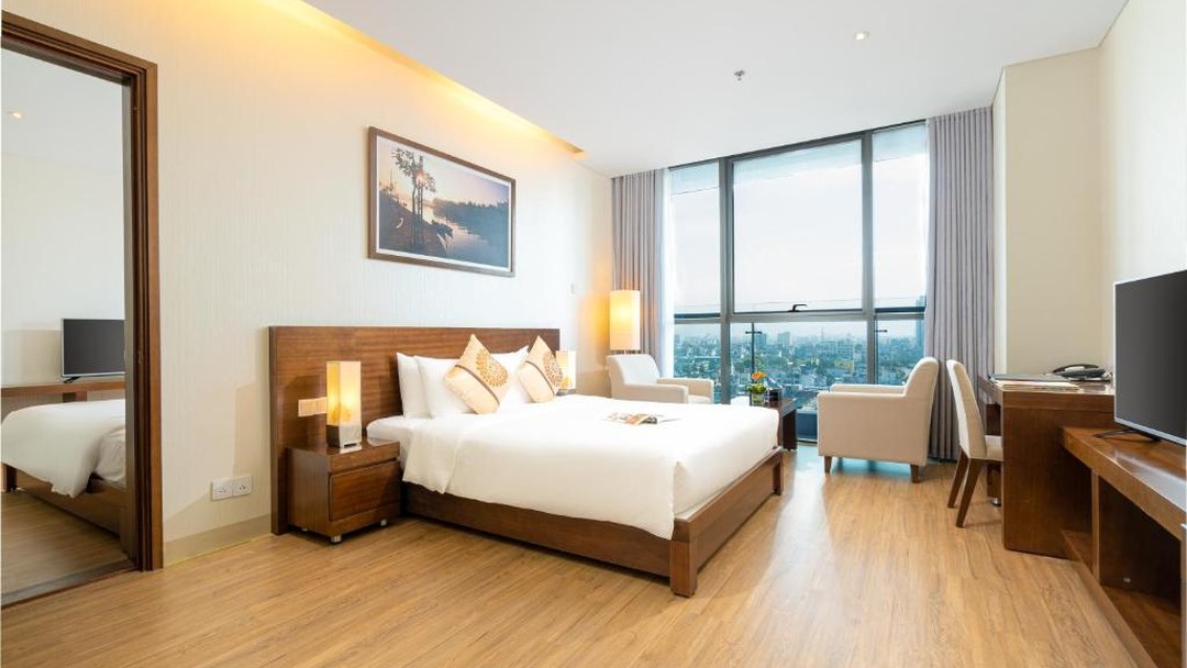 Modern hotel room with king bed and city views