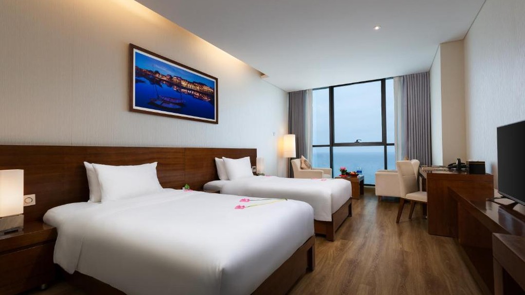 Modern hotel twin room with ocean view and floral decor
