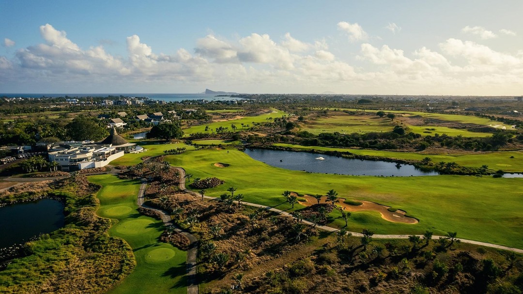 Aerial view of lush tropical golf course near ocean