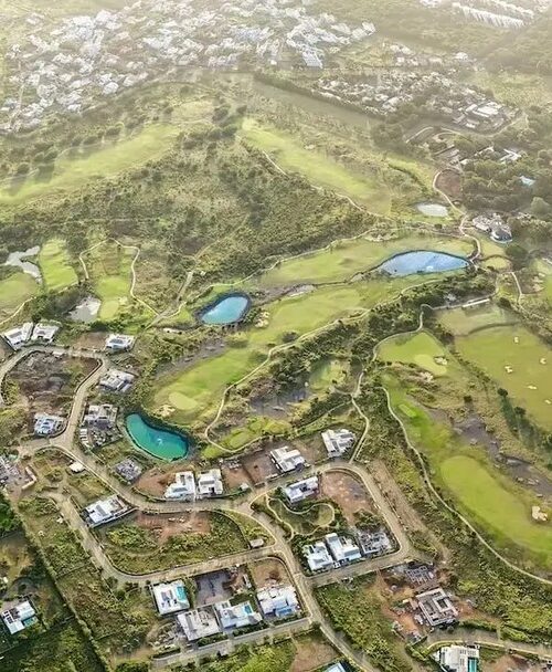Aerial view of golf course resort surrounded by luxury villas