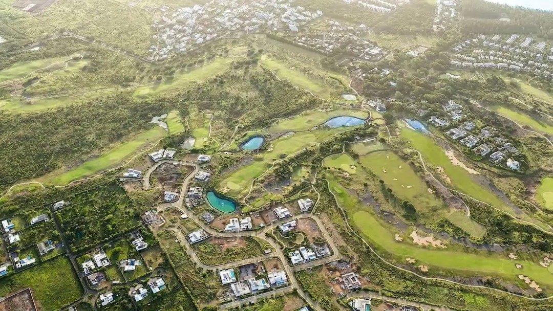 Aerial view of golf course resort surrounded by luxury villas