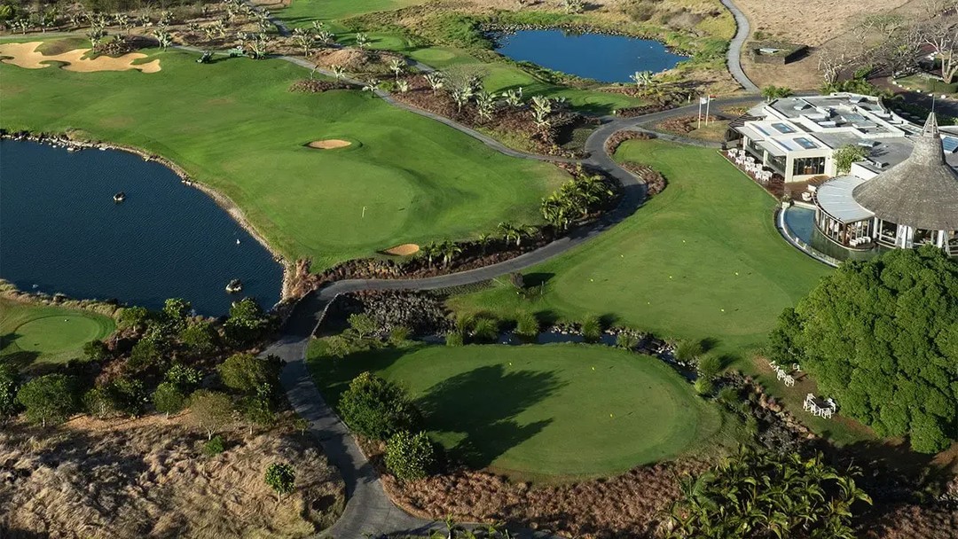 Aerial view of lush tropical golf course with water features